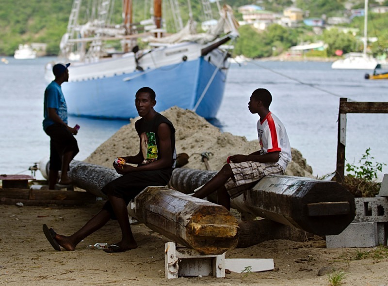 Some local sit out on the old masts of the Friendship Rose - The Caribbean