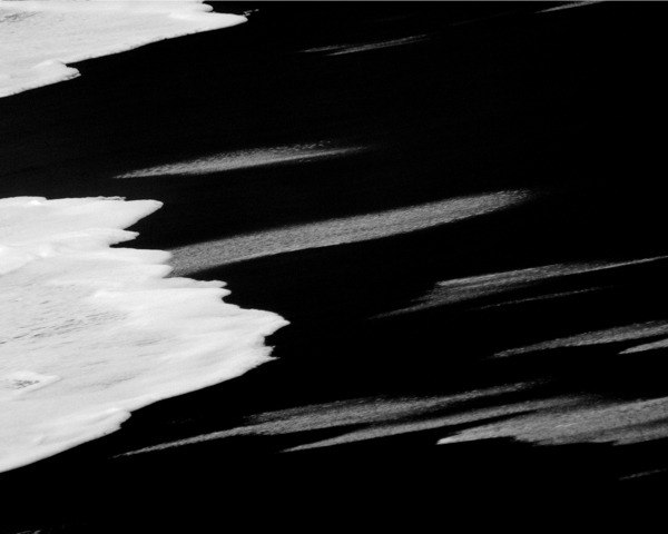 Black sandbeach - At the Water's Edge