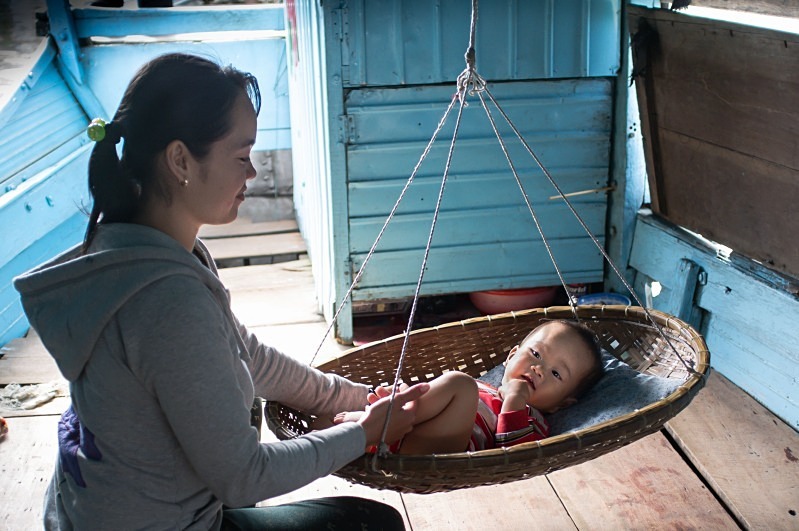 Boat lady and baby, the Perfume River, Hue - Vietnam January 2013