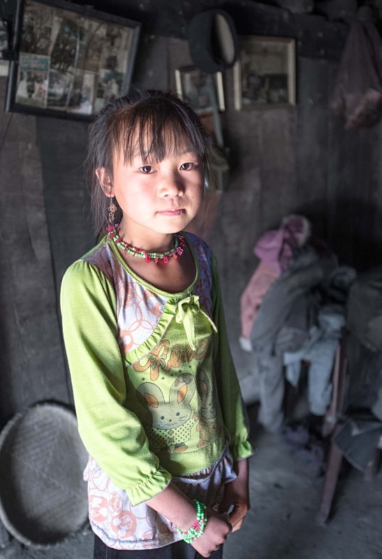 Montagnard girl in mountain village house - Vietnam January 2013