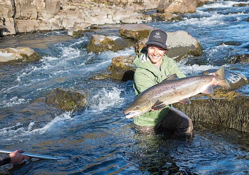 Katka holds a big salmon caught by guest Janie after a long fight. - Fishing in Iceland's Laxa I kjos River. September 2020.