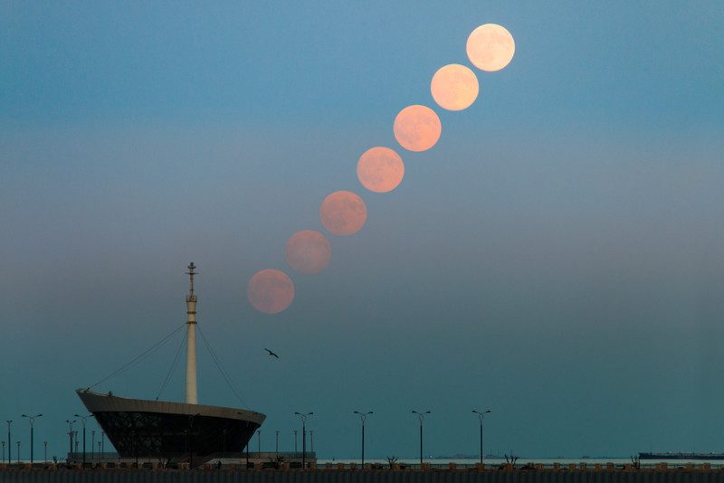 Full moon rising over baku lighthouse