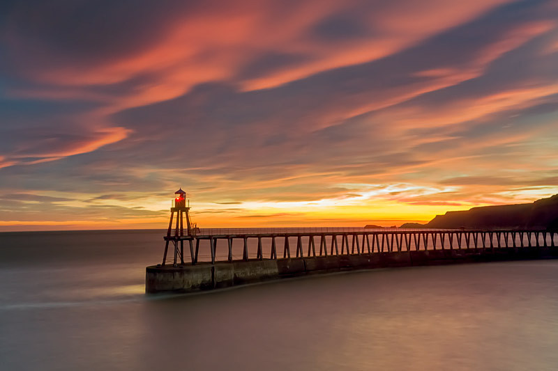 Sun rising behind Whitby's East Pier - North Yorkshire