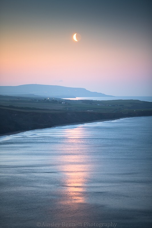 ab647 The crescent Moon over Compton Bay - The Isle of Wight by night