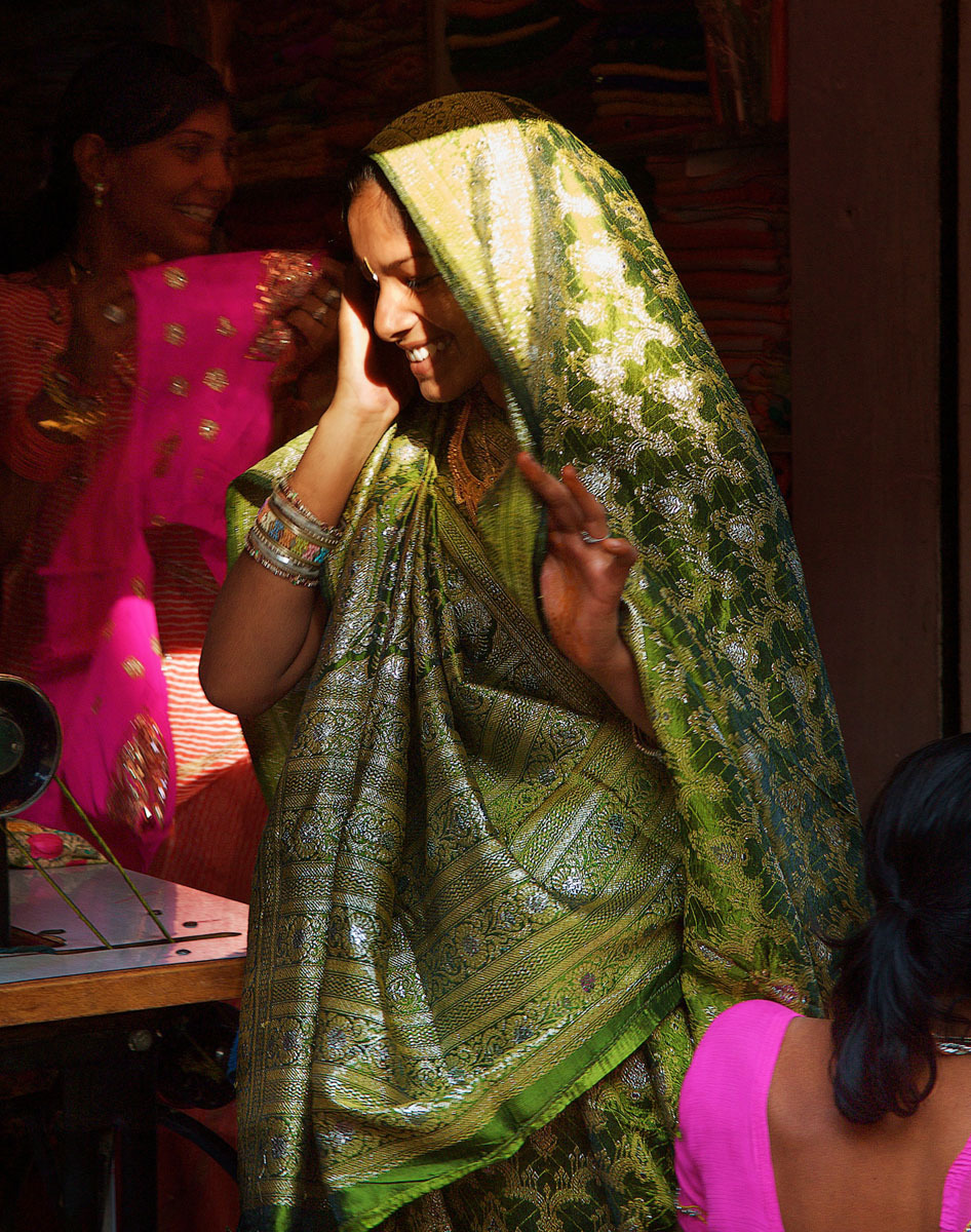 Deogarh, Rajasthan - bride being fitted for her wedding sari - India