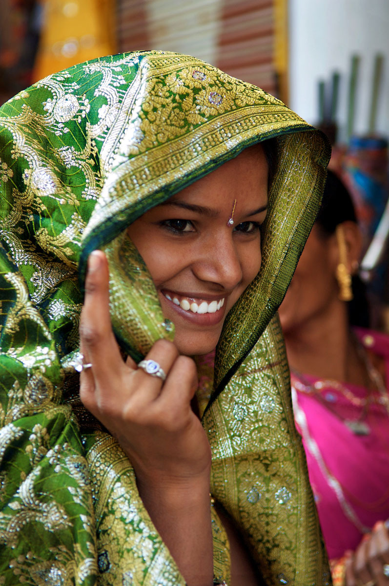 Deogarh, Rajasthan - bride being fitted for her wedding sari - India