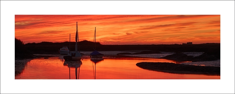 panoramic photograph of brancaster staithe at sundown