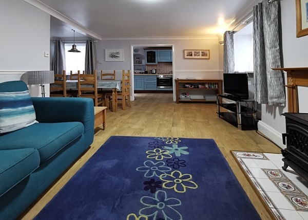 View of the living area towards the kitchen - More photos of Dolphins Holiday Let