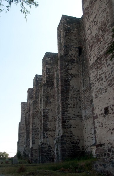 Exterior nave buttressing - San Juan Bautista, façade, portería, porciúcula door, cistern & atrial gate
