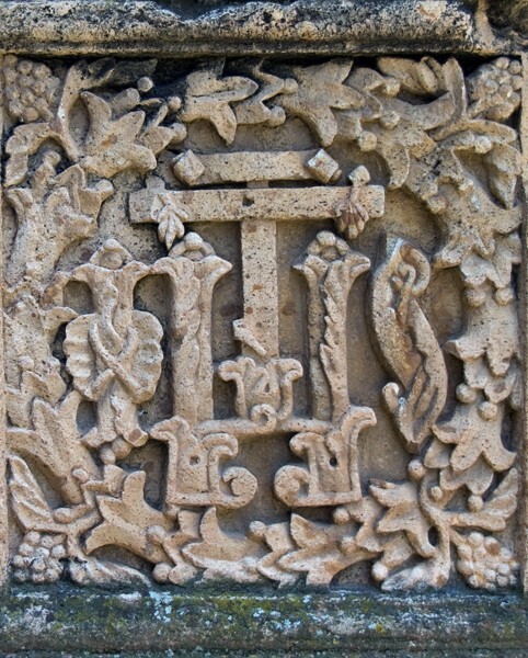 Pilaster base relief, Christogram - San Martín, porciúncula portal