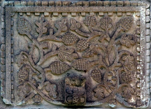 Bottom tier, sculpture niche relief (near left) - Façade