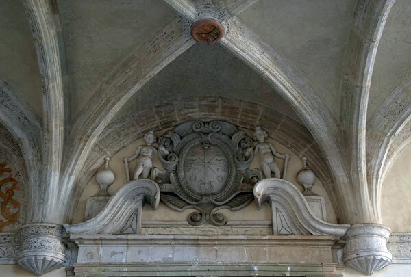 Lower cloister walk, N portal lunette reliefs - Cloister