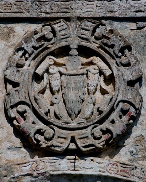 San Andrés, NW posa, E façade roundel, Franciscan insignia - San Andrés, Northwest posa chapel