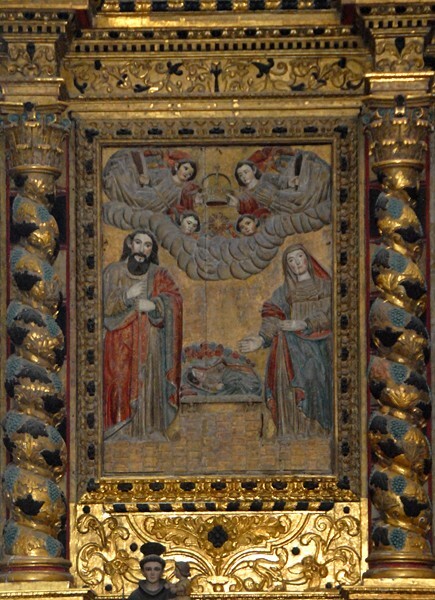 La Transfiguración, high altar, lower tier left panel, Nativity - Façade, porterías, high altar & baptismal font