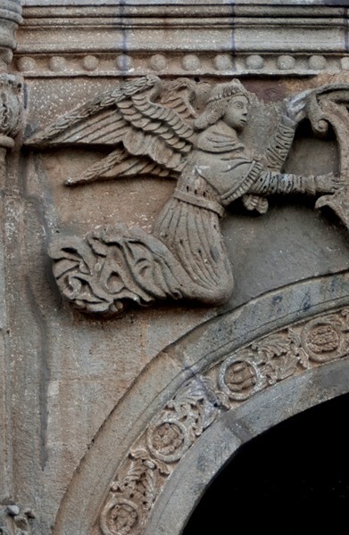 San Andrés, façade portal, left spandrel, Passion angel - San Andrés, façade, portería & atrial gate