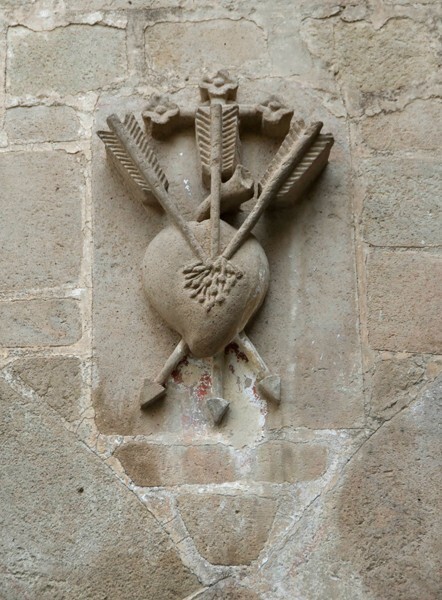 Large cloister, lower walk spandrel insignia - San Agustín, convento, large & small cloisters, apse