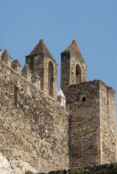 Parapet battlement & turrets - Façade, exterior buttressing, lateral portal, open & posa chapels, atrio & cross