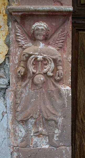 Façade portal, left pilaster relief, archangel - Nuestro Señor de Ojo Zarco (El Templo del Barrio)