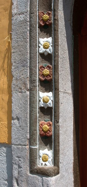 San Pedro, façade, main portal, left pilaster rosettes - Tlachichilco, Hidalgo