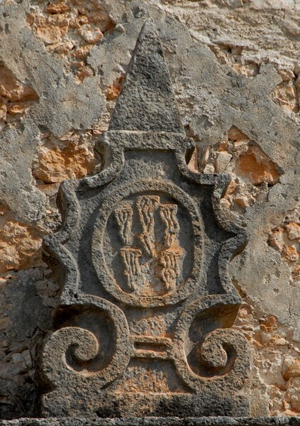 San Antonio, façade portal, cornice finial (right) Franciscan insignia - Ticum, Yucatán