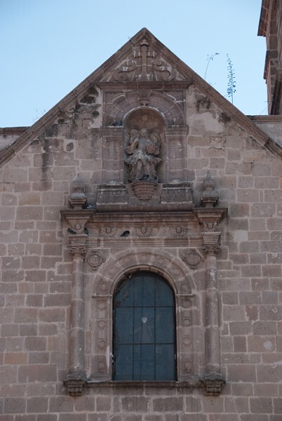 San Agustín, façade, choir loft window & gable pediment - San Agustín