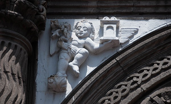 Façade portal, left spandrel relief, cherub - East (main) & South façades
