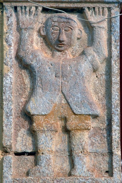 Façade portal, left pillar relief, atlante - San Miguel Arcángel