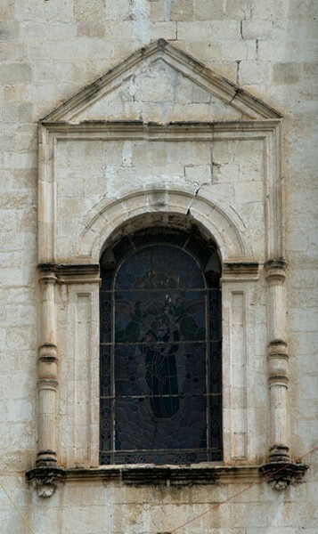 Façade, choir loft window - Façade, exterior buttressing, lateral portal, open & posa chapels, atrio & cross