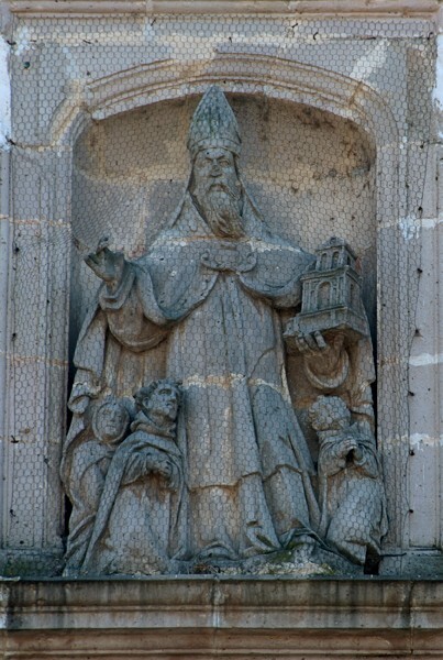 Relief, St. Augustine protecting his congregation - San Miguel Arcángel, façade & portería