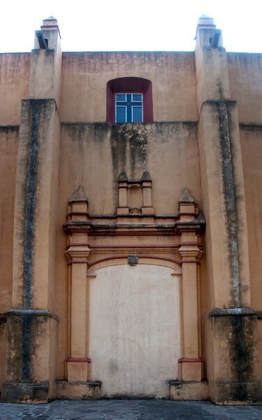 Lateral portal - Façade, lateral portal, gate cross, posa chapel, apse & atrial wall