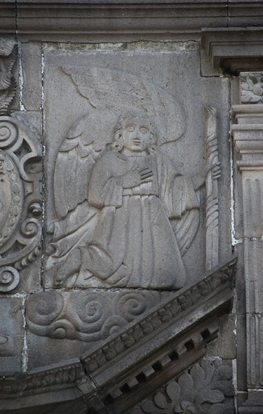 S portal left relief, angel holding a candlestick - East (main) & South façades