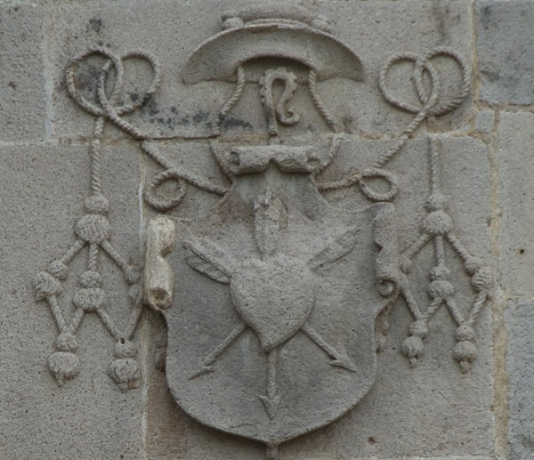 Façade pediment (left), Augustinian insignia - San Juan Bautista, façade, portería & posa chapels