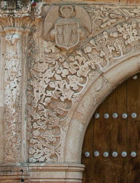Façade portal, left spandrel - San Martín, façade, posa chapel & atrial cross