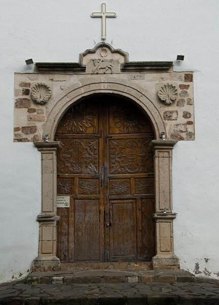 San Juan Bautista, façade, main portal alfiz - Barrio Chapels