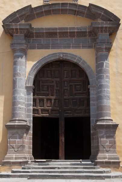 Façade, main portal - Façade, lateral portal, gate cross, posa chapel, apse & atrial wall