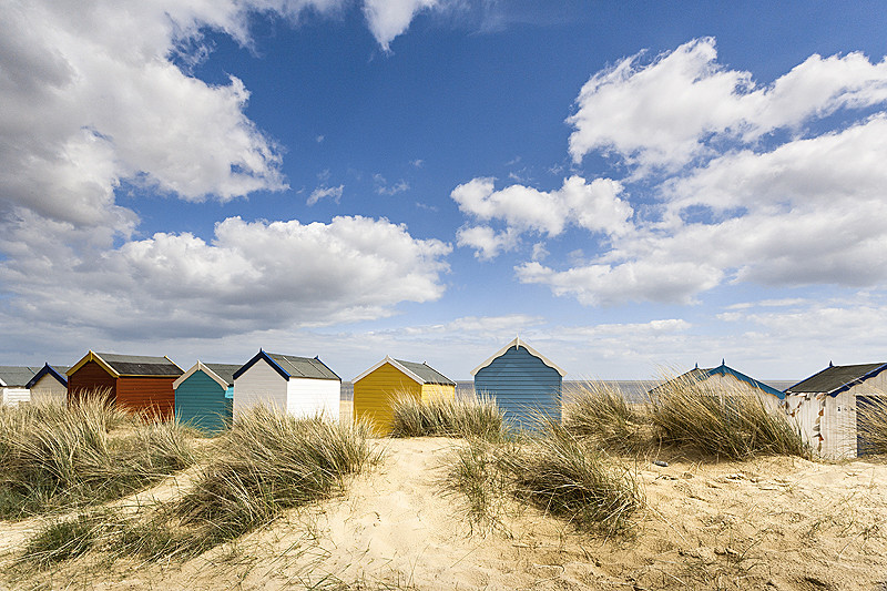Suffolk Coast landscape photography of beach huts on the beach at Southwold