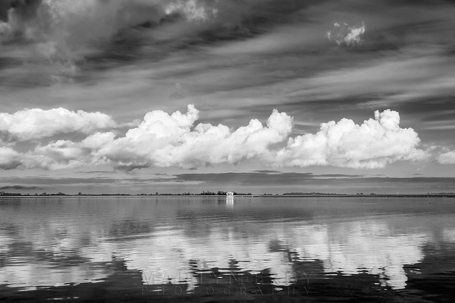 Fluffy clouds reflect in the reservoir at Grafham Water