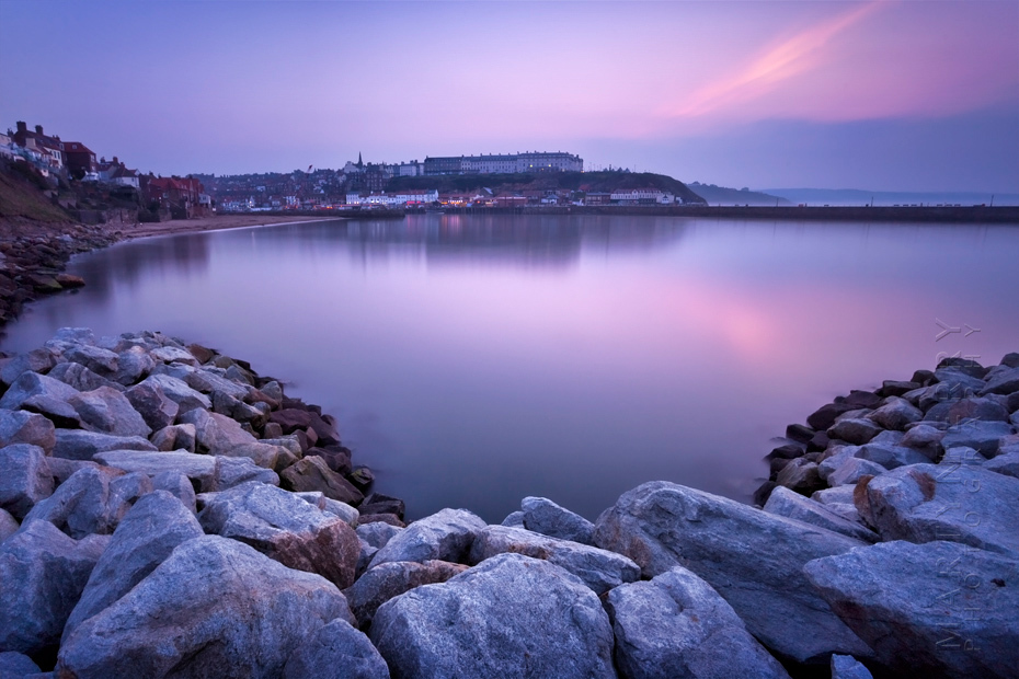 Photograph looking across Whitby bay in the evening light