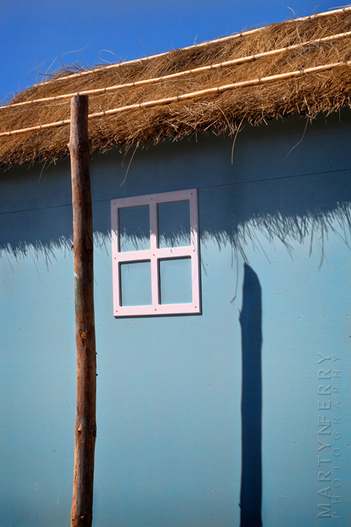 Summer image of pale blue fishing hut