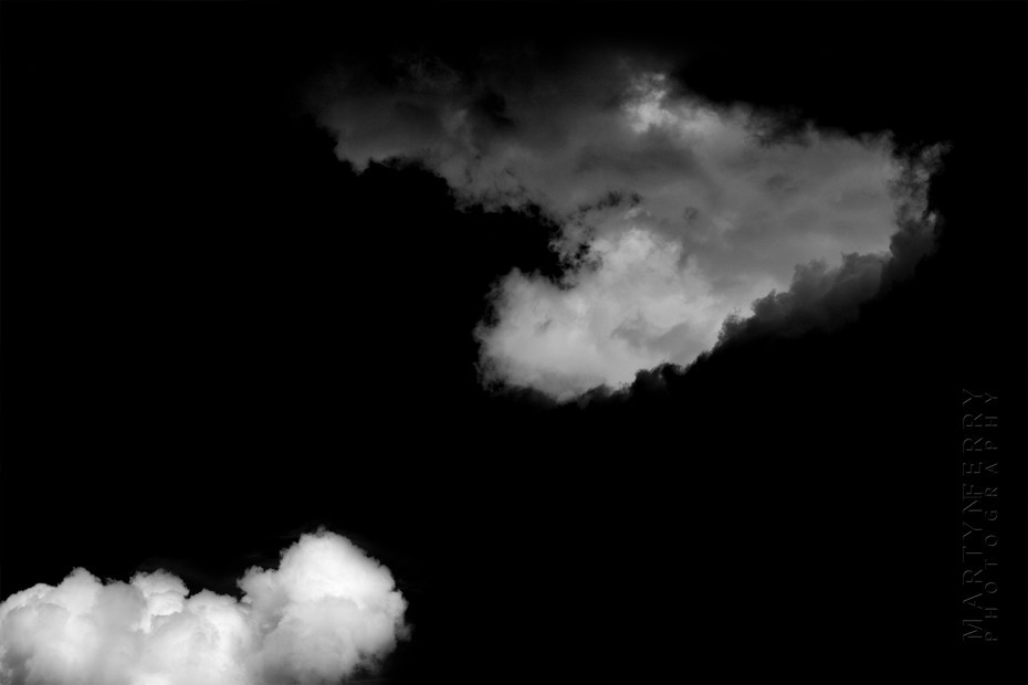 Fine art photography of clouds floating in black nothingness