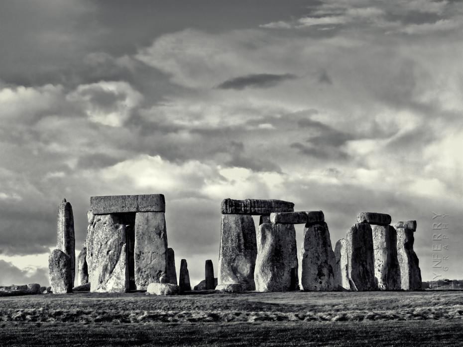 Striking black and white image of Stonehenge in sunlight