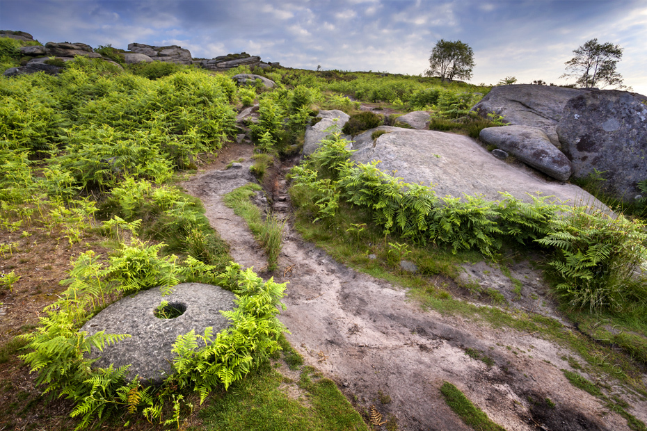Over Owler Tor pathway photograph with old millstone