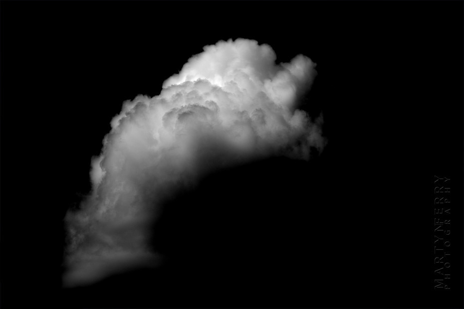 Fine art photography of clouds floating in black nothingness