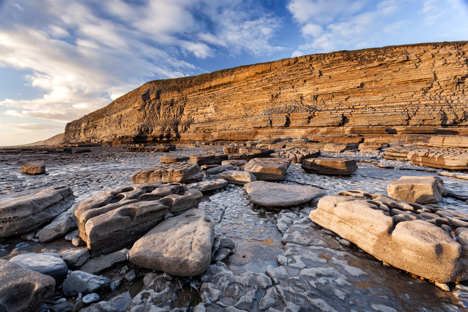 Dunraven Bay cliffs bathed in warm evening sunlight