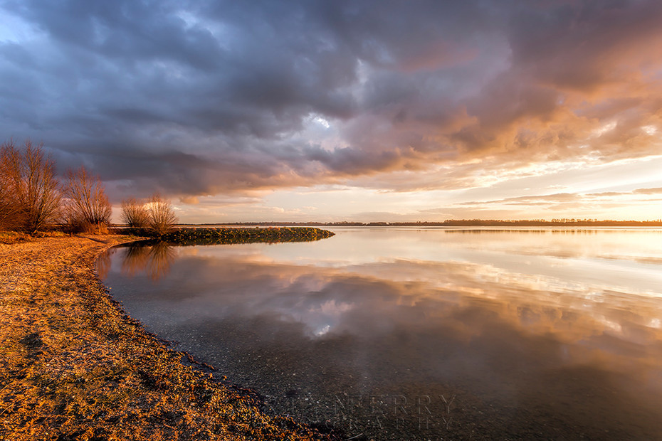 Grafham Water lake shore at sunset