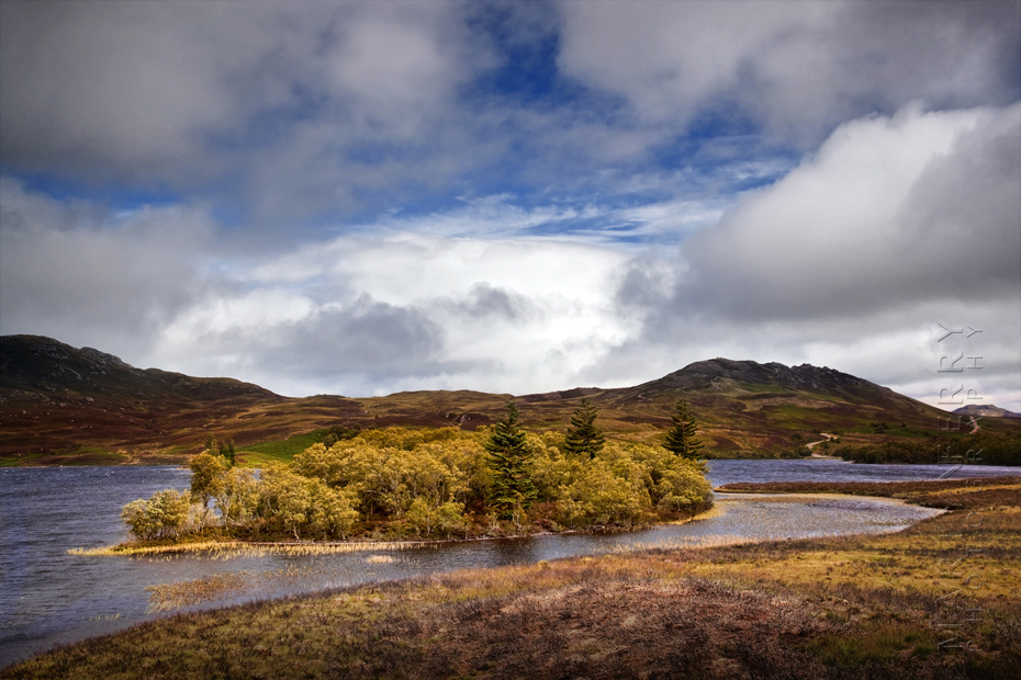 Photo of Loch Tarff on a sunny afternoon with white clouds