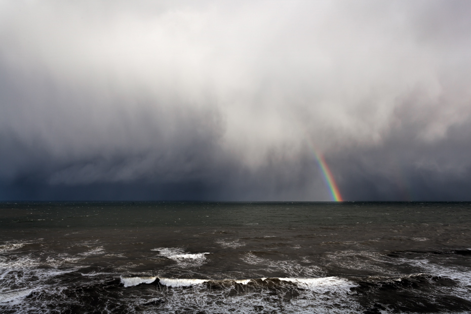 Rainbow and storm clouds over the ocean