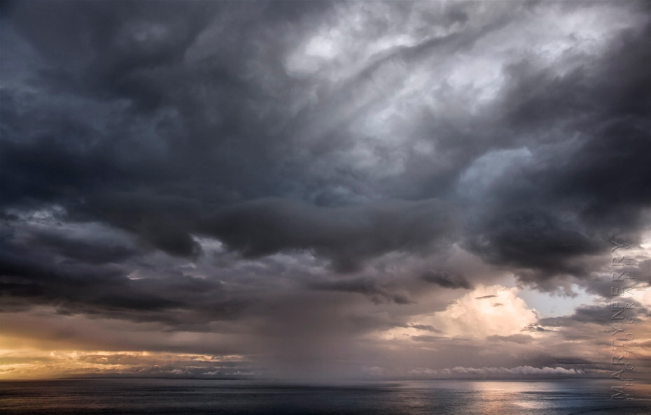Dramatic storm over the ocean at sunset