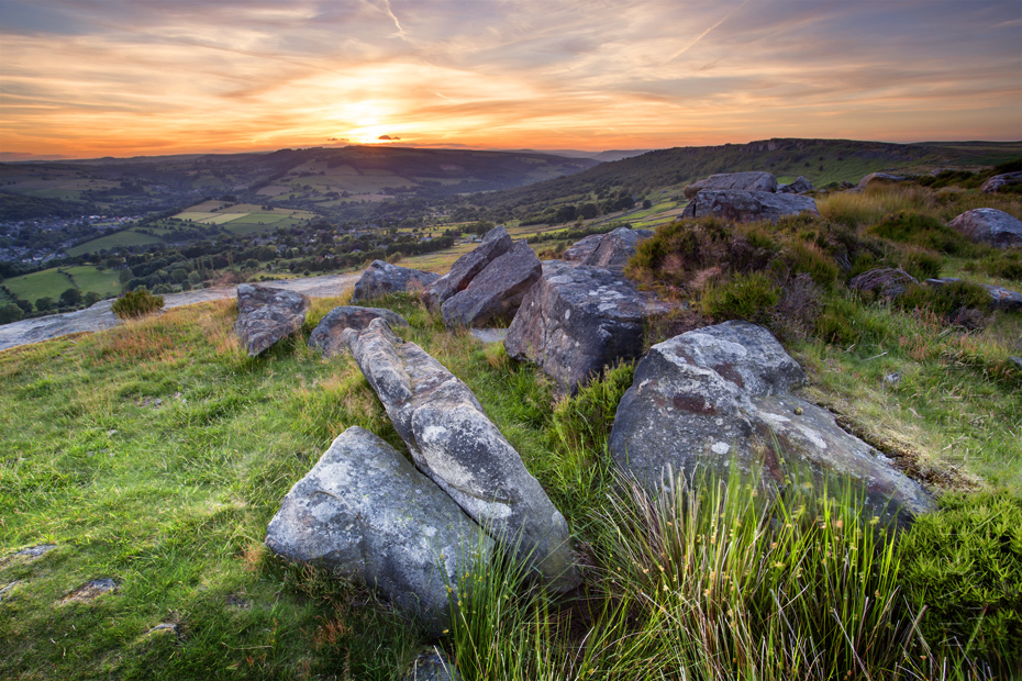 Foreground rocks at Baslow Edge with orange sunset behind