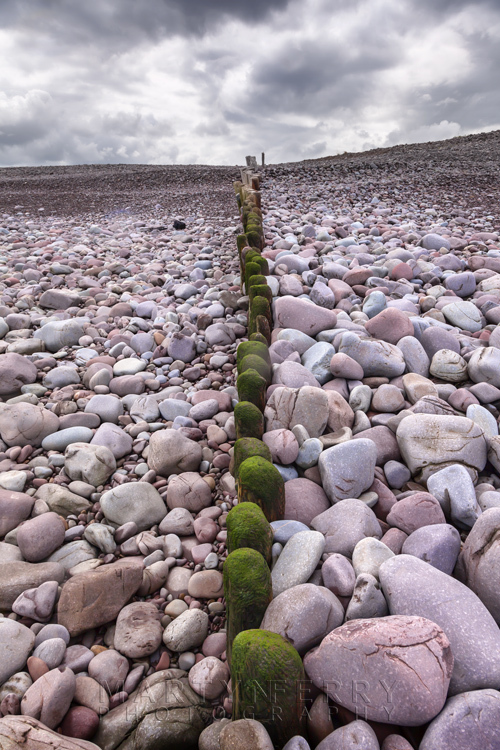 Bossington beach groynes surrounded by colourful stones
